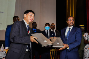 (220507) -- YAOUNDE, May 7, 2022 (Xinhua) -- Cameroonian Minister of Mines, Industry and Technological Development Gabriel Dodo Ndoke (R, front) and General Manager of Sinosteel Cam S.A. Zheng Zhenghao exchange the agreement documents in Yaounde, Cameroon, May 6, 2022. Cameroon and Sinosteel Cam S.A., a subsidiary of the China's multinational Sinosteel Corporation Ltd., on Friday signed a convention that will enable the company to invest more than 700 million U.S. dollars at an iron ore project in Cameroon's South region. (Photo by Kepseu/Xinhua)